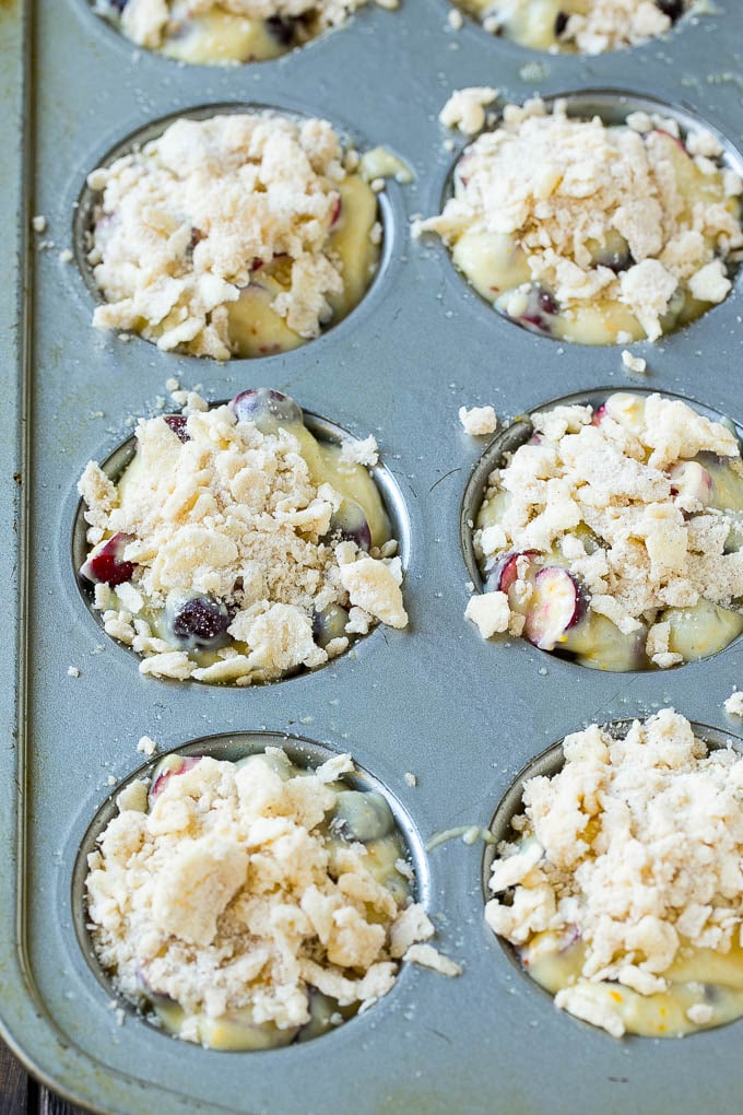Cranberry Muffins Recipe | Cranberry Orange Muffins #cranberry #muffins #orange #fall #dessert #sraye Muffins topped with streusel ready to go into the oven.