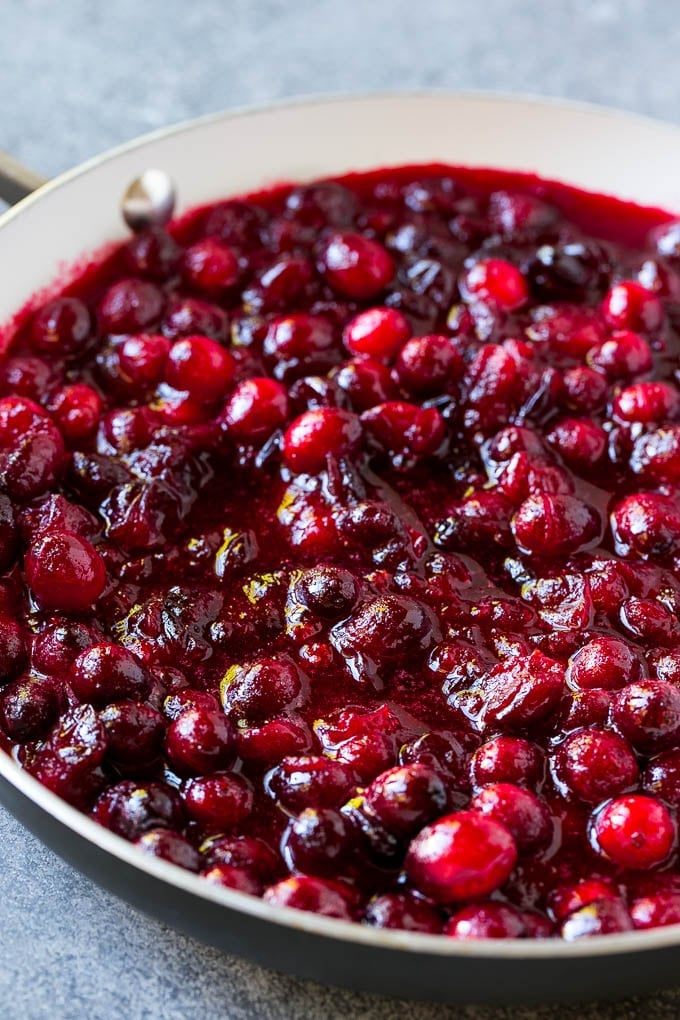 Cranberry Orange Sauce Recipe | Homemade Cranberry Sauce | Fresh Cranberry Sauce #cranberry #orange #fall #thanksgiving #sauce #dinner #sraye Cranberry orange sauce simmering in a skillet.