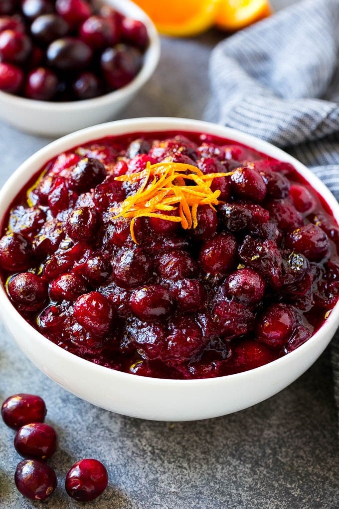 Cranberry Orange Sauce Recipe | Homemade Cranberry Sauce | Fresh Cranberry Sauce #cranberry #orange #fall #thanksgiving #sauce #dinner #sraye A bowl of cranberry orange sauce topped with fresh orange zest.