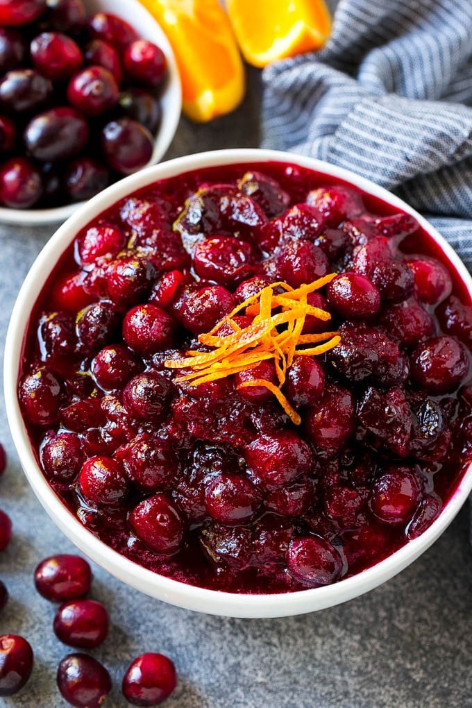 Cranberry Orange Sauce Recipe | Homemade Cranberry Sauce | Fresh Cranberry Sauce #cranberry #orange #fall #thanksgiving #sauce #dinner #sraye Cranberry orange sauce, topped with fresh orange zest in a serving bowl.
