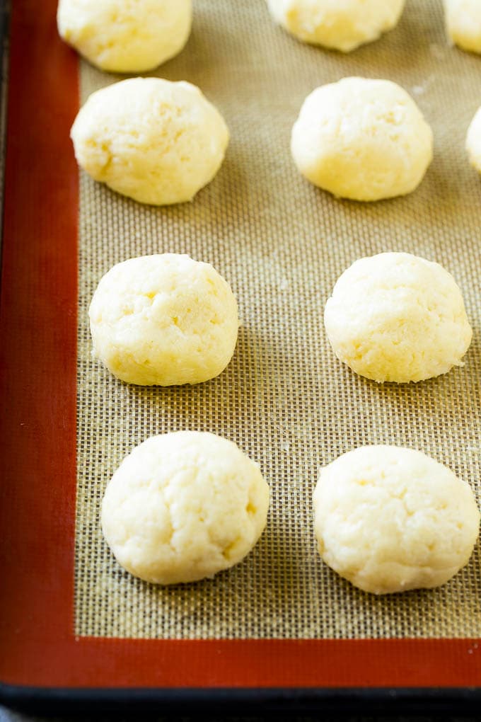 Gooey Butter Cookies Recipe | Cake Mix Cookies | Sprinkle Cookies | Christmas Cookies #cookies #butter #sprinkles #christmas #dessert #baking #sraye Balls of dough on a baking sheet.