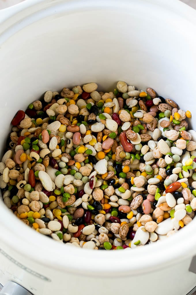 Ham and Bean Soup Recipe | Slow Cooker Ham and Bean Soup | Crockpot Ham and Bean Soup | Leftover Ham Recipe #ham #beans #soup #slowcooker #crockpot #dinner #sraye A mixture of dried beans in a crock pot.