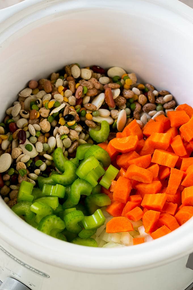 Ham and Bean Soup Recipe | Slow Cooker Ham and Bean Soup | Crockpot Ham and Bean Soup | Leftover Ham Recipe #ham #beans #soup #slowcooker #crockpot #dinner #sraye Dried beans, carrots, onions and celery in the slow cooker.