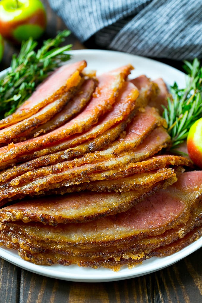 Honey Baked Ham Recipe | Glazed Ham | Holiday Ham #ham #dinner #sraye #christmas #thanksgiving #easter Sliced honey baked ham on a serving plate.