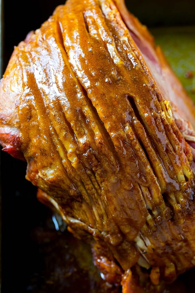 Honey Baked Ham Recipe | Glazed Ham | Holiday Ham #ham #dinner #sraye #christmas #thanksgiving #easter A ham coated in sugar glaze in a baking pan.