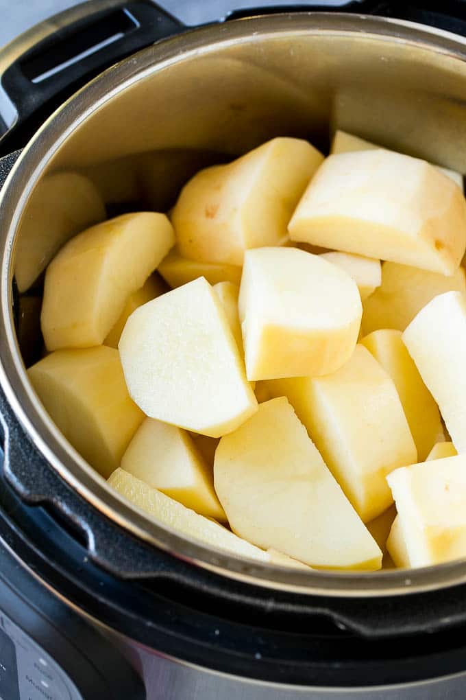 Instant Pot Mashed Potatoes Recipe | Pressure Cooker Mashed Potatoes | Easy Mashed Potatoes #potatoes #sidedish #instantpot #thanksgiving #dinner #sraye Peeled potatoes in an Instant Pot.