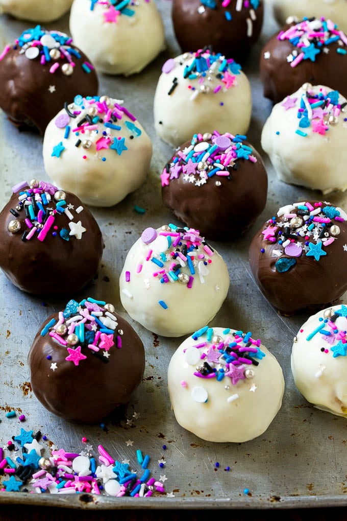 Oreo Balls Recipe | Oreo Truffles | Homemade Candy #truffles #candy #oreos #chocolate #sprinkles #dessert #christmas #sraye Assorted colors of Oreo balls on a sheet pan.