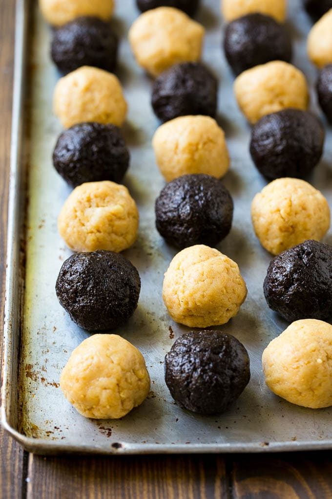 Oreo Balls Recipe | Oreo Truffles | Homemade Candy #truffles #candy #oreos #chocolate #sprinkles #dessert #christmas #sraye Oreo ball centers made from vanilla and chocolate Oreos on a sheet pan.