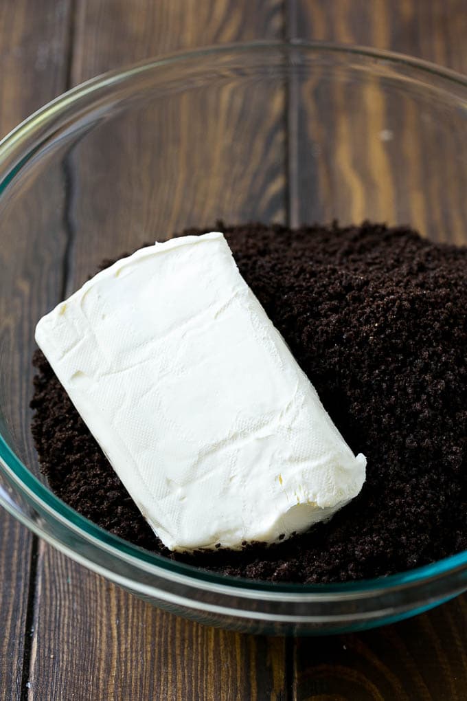 Oreo Balls Recipe | Oreo Truffles | Homemade Candy #truffles #candy #oreos #chocolate #sprinkles #dessert #christmas #sraye Cookie crumbs and cream cheese in a bowl.