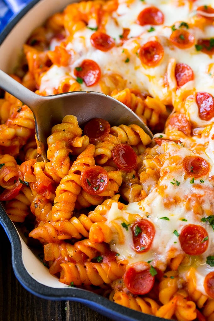 Pizza Pasta Recipe | Pepperoni Pasta | Sausage Pasta #italian #pepperoni #sausage #pizza #pasta #dinner #sraye #onepot A pan of pizza pasta with a serving spoon in it.