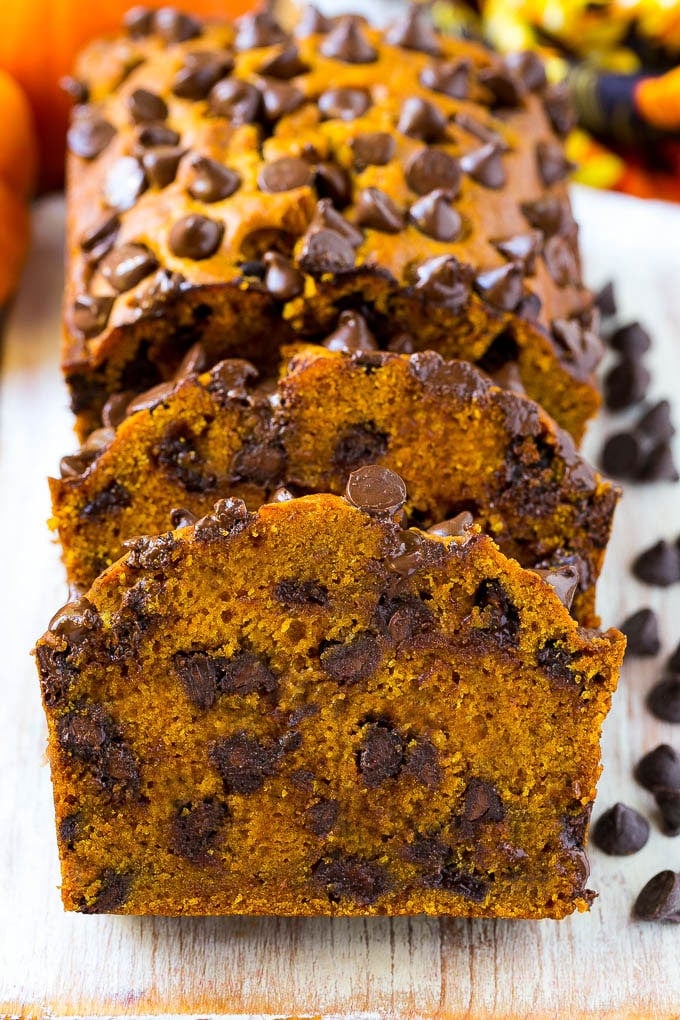 Pumpkin Chocolate Chip Bread Recipe | Pumpkin Bread | Chocolate Pumpkin Bread #pumpkin #bread #fall #chocolate #baking #dessert #sraye Sliced pumpkin chocolate chip bread on a serving board.