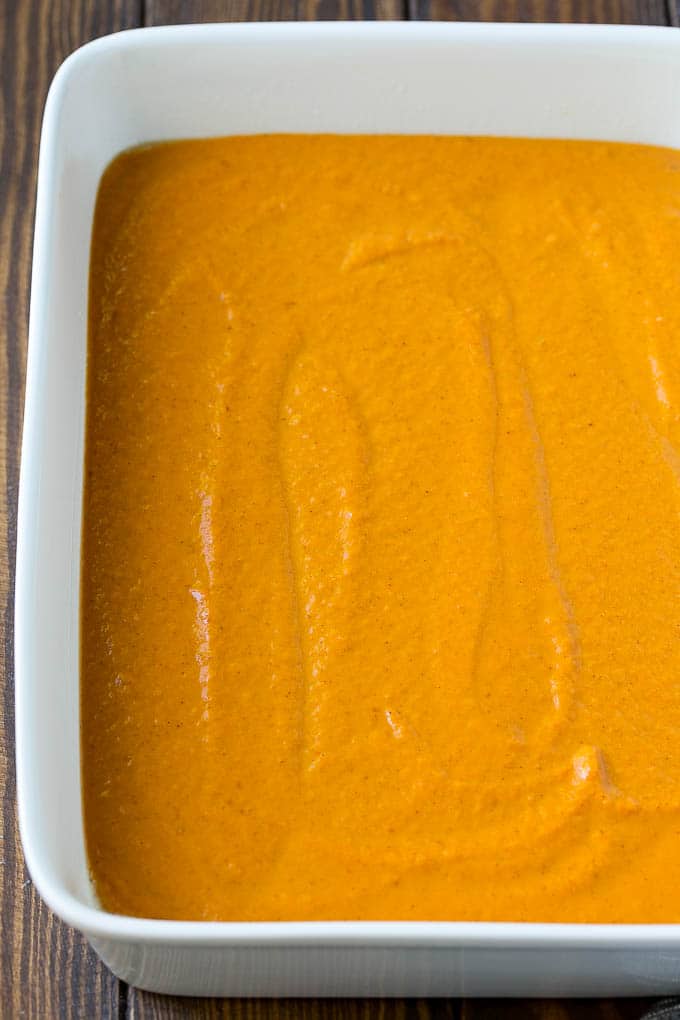 Pumpkin Dump Cake Recipe | Pumpkin Cake | Pumpkin Pie Cake #pumpkin #cake #pecans #fall #thanksgiving #dessert #sraye Pumpkin pie filling poured into a baking dish.