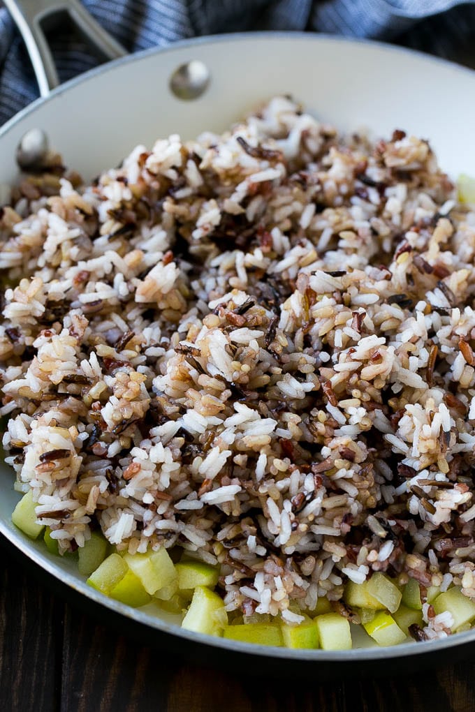 Wild Rice Pilaf Recipe | Thanksgiving Side Dish | Rice Pilaf #rice #apple #cranberry #fall #glutenfree #thanksgiving #sraye WIld rice, onions and apples in a skillet.
