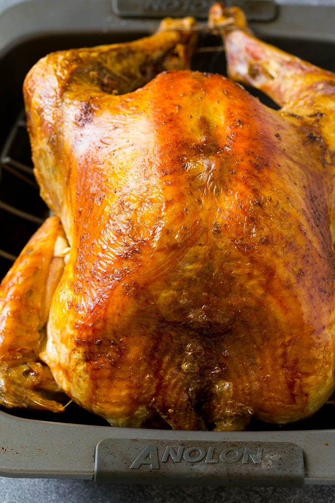 Roast Turkey Recipe | Thanksgiving Turkey | Holiday Turkey | Baked Turkey #turkey #thanksgiving #christmas #dinner #glutenfree #sraye A roasted turkey in a baking pan.