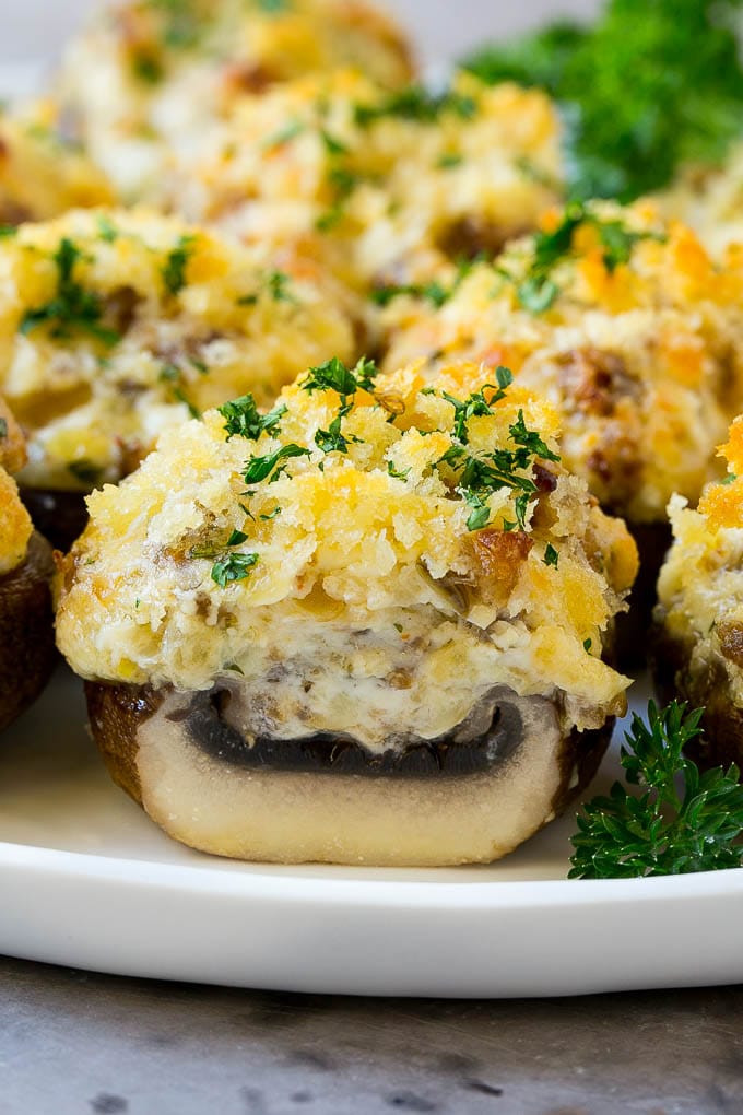Sausage Stuffed Mushrooms Recipe | Stuffed Mushrooms | Mushroom Appetizer #mushrooms #sausage #appetizer #lowcarb #keto #sraye A cross section of a sausage stuffed mushroom on a serving platter.