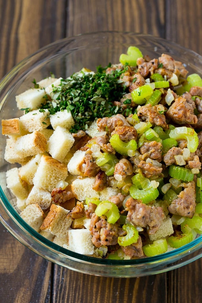 Sausage Stuffing Recipe | Thanksgiving Stuffing | Make Ahead Stuffing #stuffing #thanksgiving #sausage #sidedish #dinner #sraye Meat, sauteed vegetables and bread cubes in a mixing bowl.