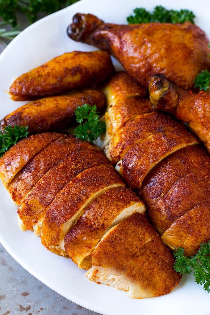 Smoked Chicken Recipe | Whole Smoked Chicken | BBQ Chicken #chicken #smoker #BBQ #dinner #sraye #glutenfree #lowcarb Carved smoked chicken including drumsticks, wings and chicken breasts on a serving platter.