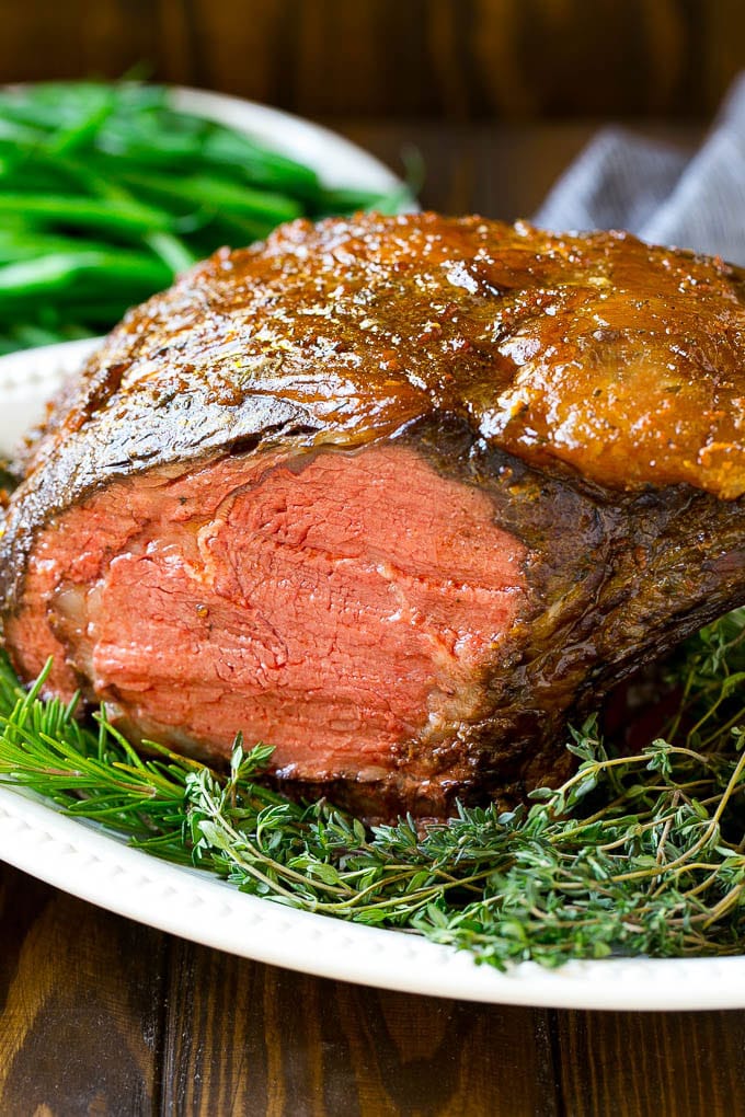 Smoked Prime Rib Recipe | Easy Prime Rib | Smoked Beef | Holiday Prime Rib #primerib #beef #smoker #dinner #sraye #christmas #thanksgiving #lowcarb #keto A smoked prime rib roast cooked to medium rare on a serving platter.