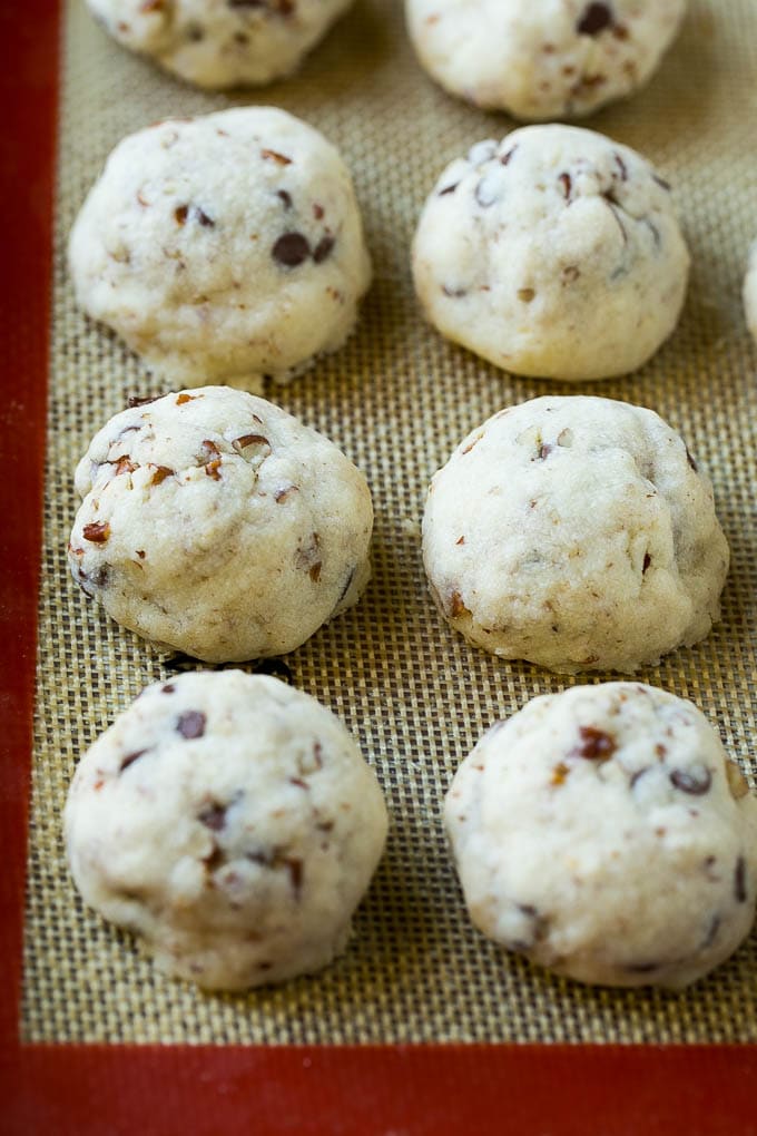 Snowball Cookies Recipe | Mexican Wedding Cookies | Russian Tea Cakes #cookies #pecan #chocolate #baking #dessert #christmas #sraye Baked snowball cookies on a sheet pan.