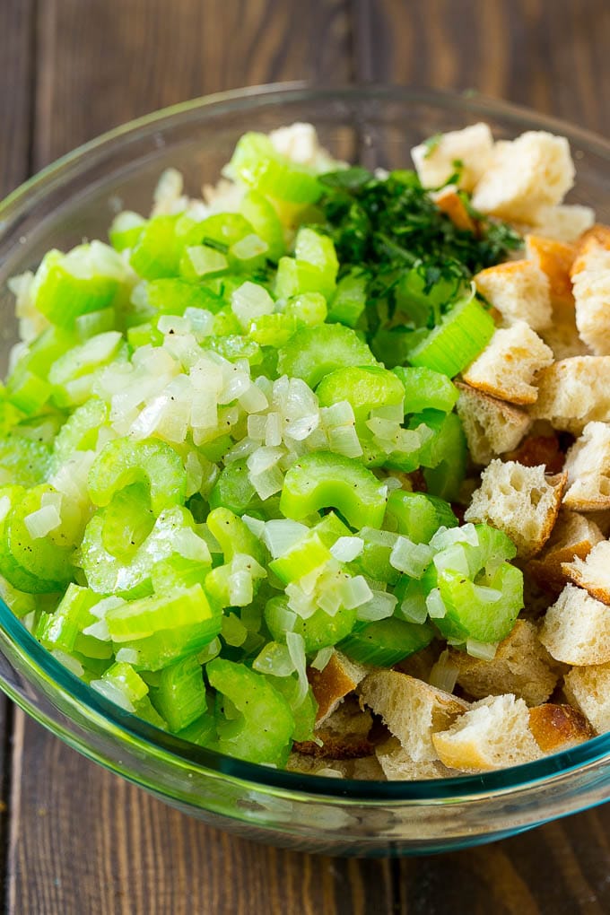 Turkey Stuffing Recipe | Thanksgiving Stuffing | Classic Stuffing #thanksgiving #stuffing #sidedish #fall #sraye Bread cubes, celery, onion and herbs in a mixing bowl.