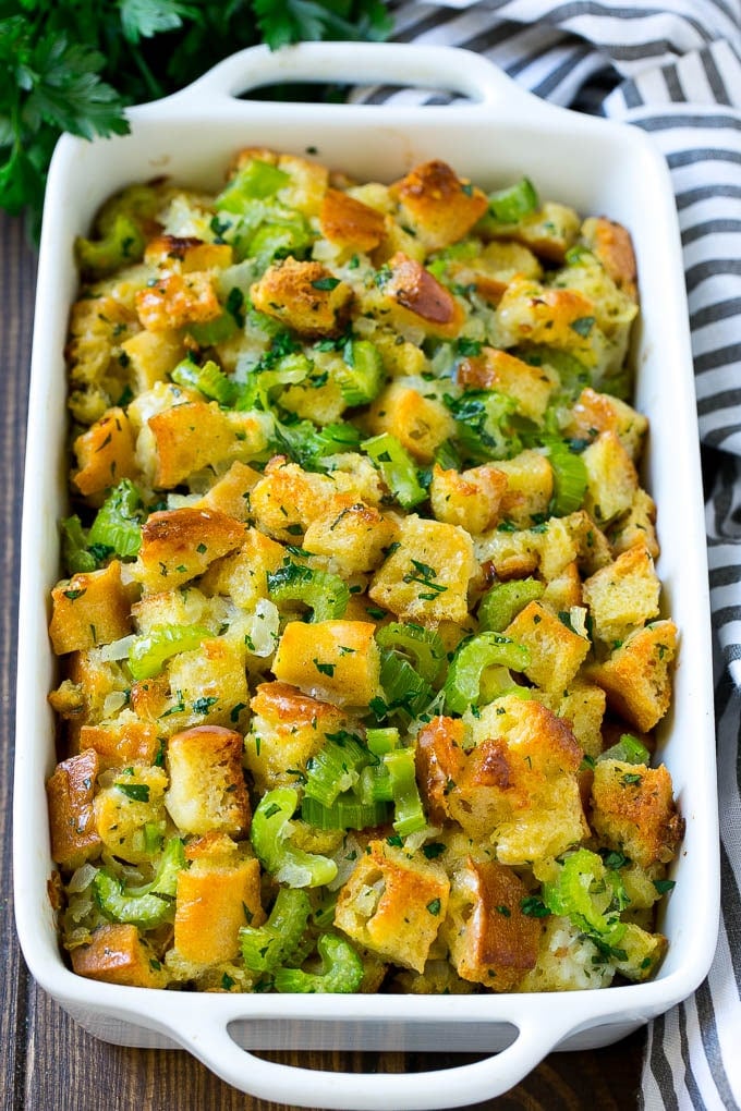Turkey Stuffing Recipe | Thanksgiving Stuffing | Classic Stuffing #thanksgiving #stuffing #sidedish #fall #sraye Baked turkey stuffing in a dish topped with fresh parsley.