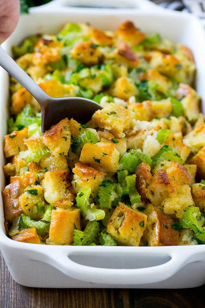 Turkey Stuffing Recipe | Thanksgiving Stuffing | Classic Stuffing #thanksgiving #stuffing #sidedish #fall #sraye Turkey stuffing in a casserole dish with a serving spoon in it.