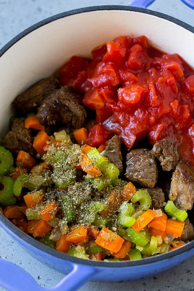 Vegetable Beef Soup Recipe | Beef Vegetable Soup | Beef Soup #beef #veggies #soup #dinner #glutenfree #sraye Stew meat, veggies, tomatoes and herbs in a pot.