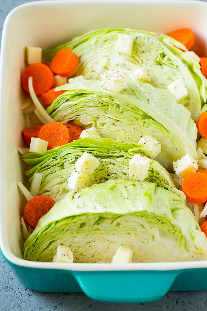 Braised Cabbage Recipe | Easy Cabbage Recipe #cabbage #lowcarb #keto #carrots #veggies #vegetarian #dinner #sraye Cabbage, carrots, onions, pieces of butter and seasonings in a baking dish.