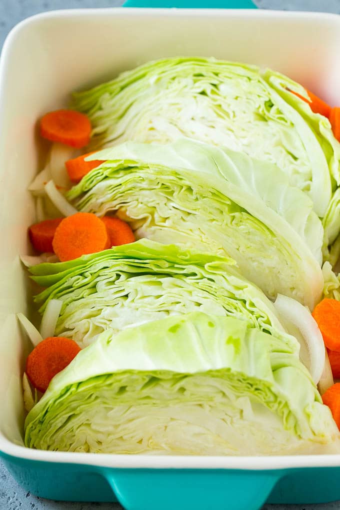 Braised Cabbage Recipe | Easy Cabbage Recipe #cabbage #lowcarb #keto #carrots #veggies #vegetarian #dinner #sraye Wedges of cabbage, sliced carrots and onion in a baking dish.