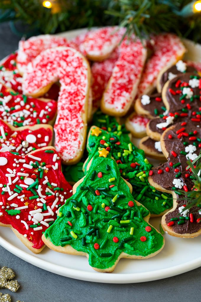 Christmas Sugar Cookies Recipe | Christmas Cookies #cookies #frosting #sprinkles #sugarcookies #christmas #dessert #sraye A serving plate of Christmas sugar cookies decorated with frosting and sprinkles.