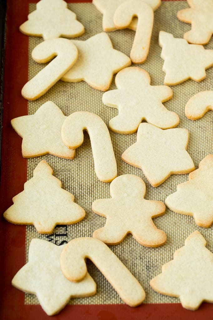 Christmas Sugar Cookies Recipe | Christmas Cookies #cookies #frosting #sprinkles #sugarcookies #christmas #dessert #sraye Cut out cookies on a sheet pan.