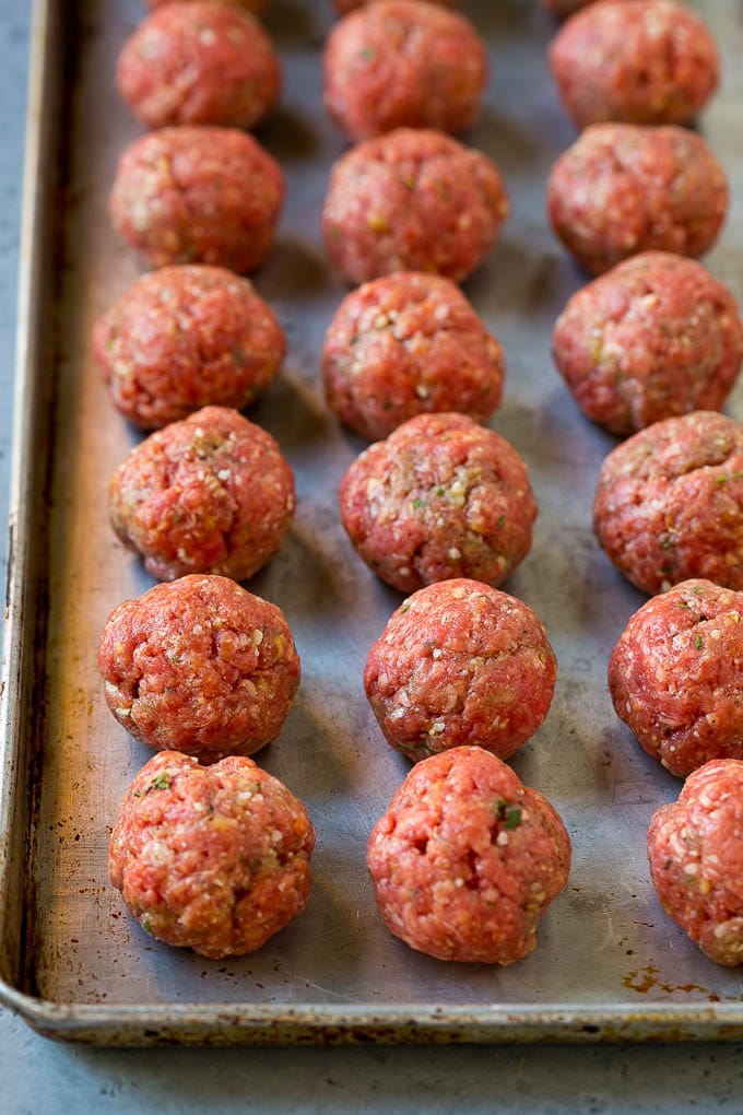 Italian Meatball Soup Recipe | Meatball Soup | Beef Meatballs #meatballs #beef #soup #italian #dinner #sraye #comfortfood Raw meatballs on a sheet pan ready to go into the oven.