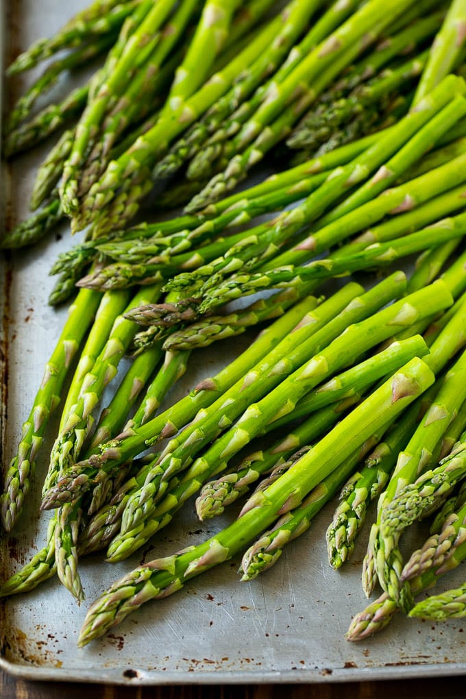 Roasted Asparagus Recipe | Baked Asparagus | Asparagus Side Dish #asparagus #garlic #sidedish #keto #lowcarb #dinner #sraye Raw asparagus spears on a sheet pan.