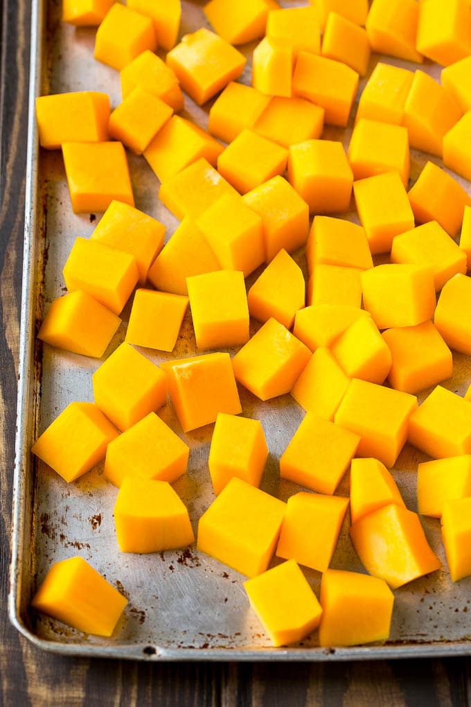 Roasted Butternut Squash Recipe | Baked Butternut Squash | Butternut Squash Side Dish #butternutsquash #squash #fall #vegetarian #dinner #sraye Raw cubed squash on a sheet pan.