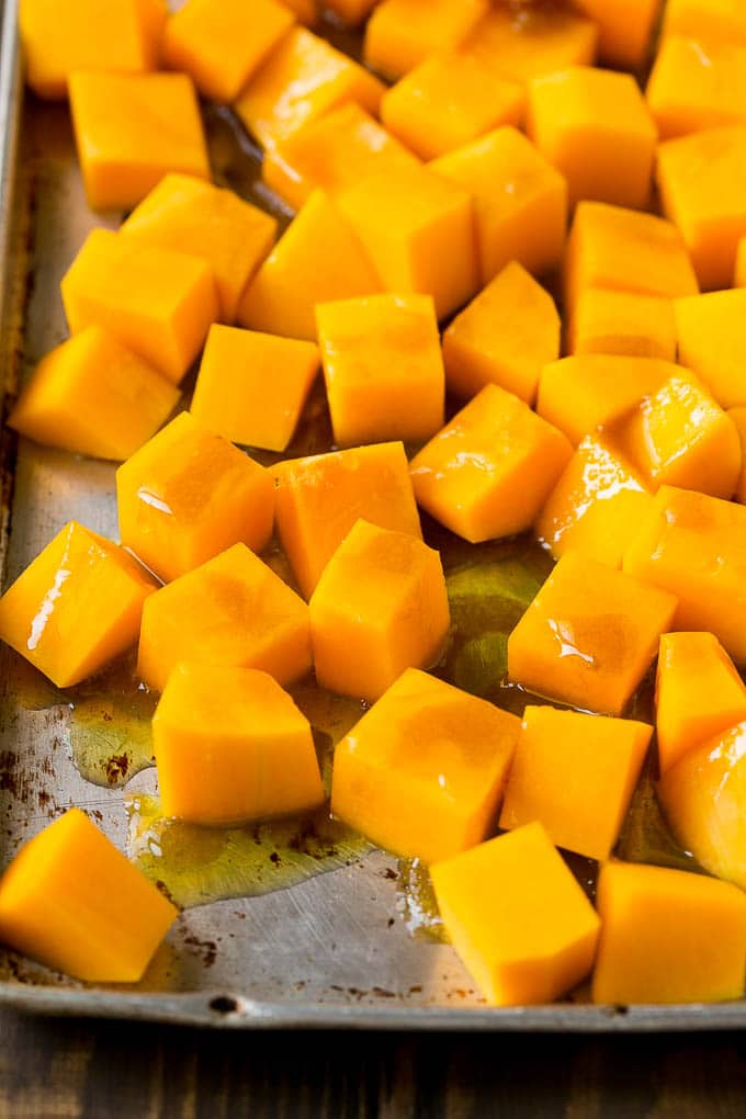 Roasted Butternut Squash Recipe | Baked Butternut Squash | Butternut Squash Side Dish #butternutsquash #squash #fall #vegetarian #dinner #sraye Cubes of winter squash coated in olive oil, brown sugar and maple syrup.