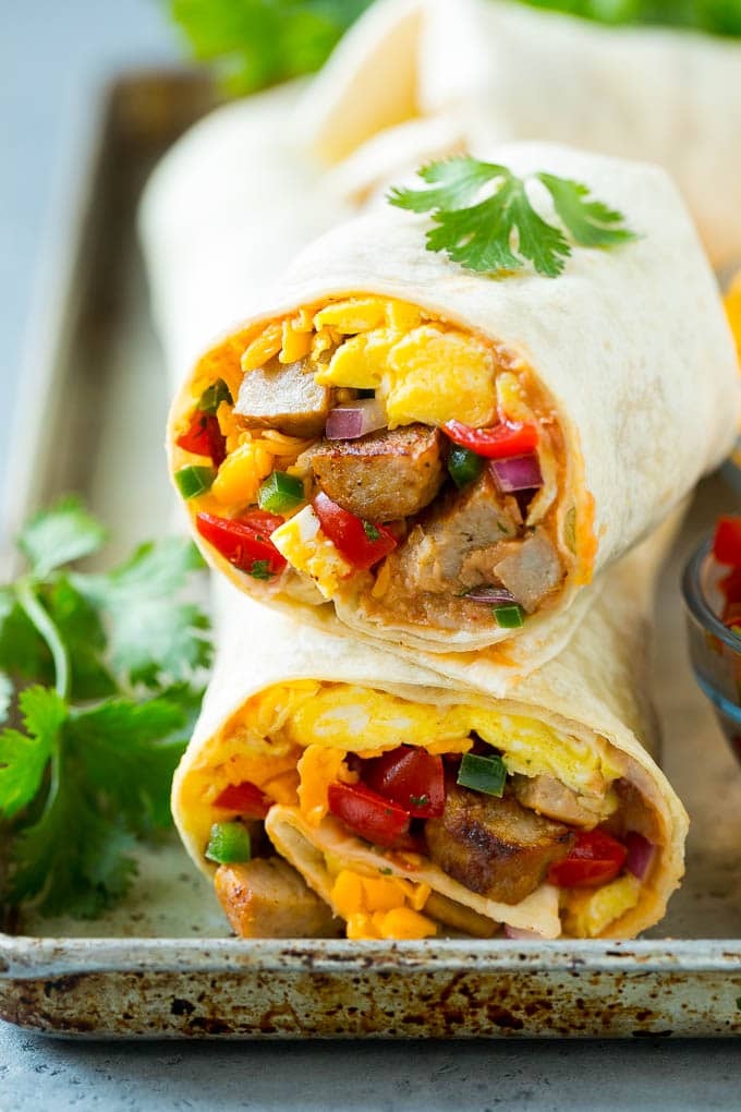 Breakfast Burrito Recipe | Sausage Breakfast Burrito #breakfast #sausage #eggs #burrito #sraye A cross section of a breakfast burrito filled with eggs, sausage, beans and cheese.