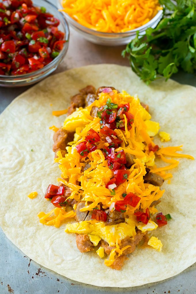 Breakfast Burrito Recipe | Sausage Breakfast Burrito #breakfast #sausage #eggs #burrito #sraye A flour tortilla topped with eggs, sausage, cheese and pico de gallo salsa.