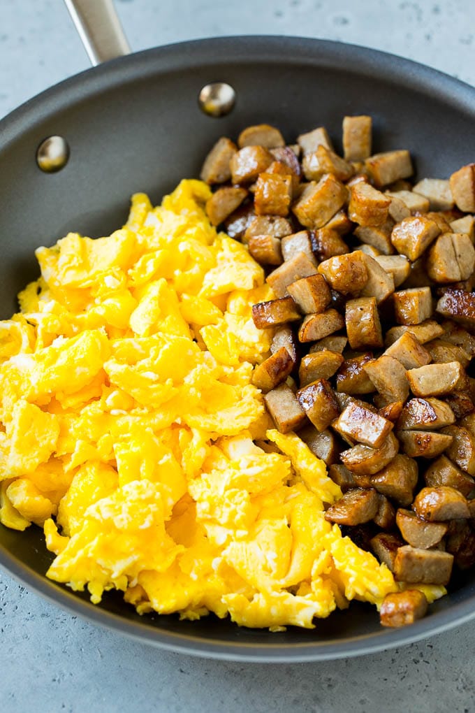Breakfast Burrito Recipe | Sausage Breakfast Burrito #breakfast #sausage #eggs #burrito #sraye Diced sausage and scrambled eggs in a pan.