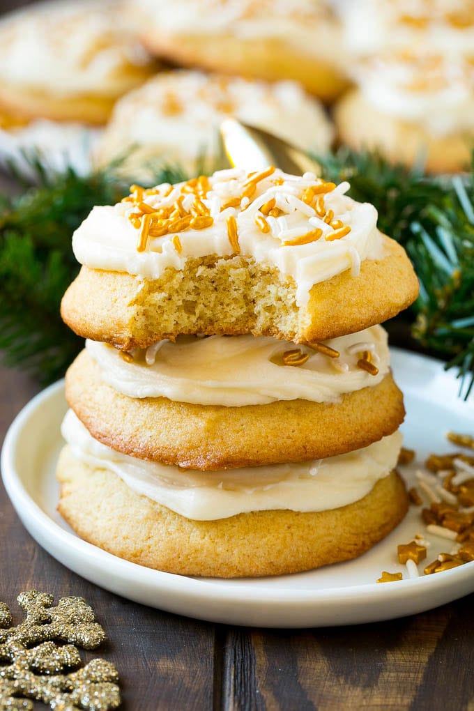 Eggnog Cookies Recipe | Holiday Cookies | Christmas Cookies #cookies #eggnog #baking #christmas #sprinkles #dessert #sraye A stack of eggnog cookies with a bite taken out of one.