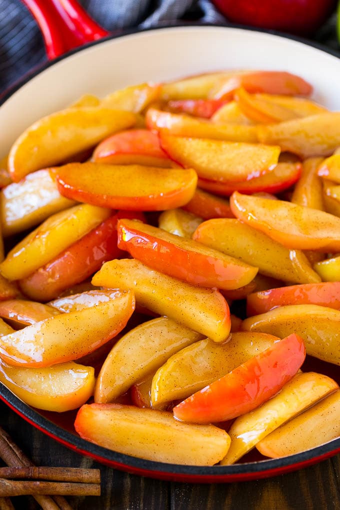 Fried Apples Recipe | Sauteed Apples | Cinnamon Sugar Apples #apples #cinnamon #sugar #sidedish #dessert #sraye #fall Southern fried apples coated in butter, cinnamon and sugar in a red skillet.