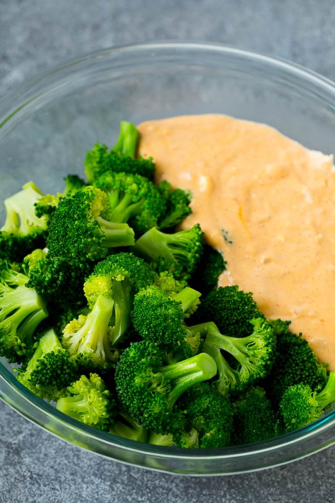 Broccoli Casserole Recipe | Broccoli and Cheese Casserole | Baked Broccoli #broccoli #cheese #casserole #sidedish #dinner #sraye Cooked florets and cheese sauce in a mixing bowl.