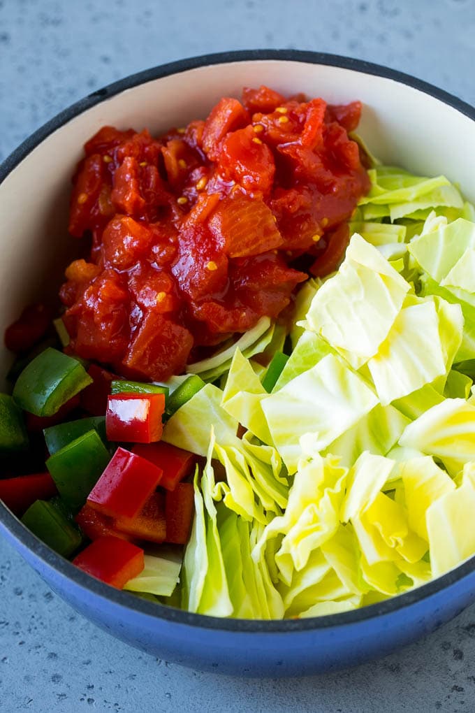 Cabbage Soup Recipe | Vegetable Soup | Veggie Soup | Healthy Soup #soup #healthy #cleaneating #cabbage #vegetables #veggies #dinner #sraye Red and green peppers, diced tomatoes and raw veggies in a large pot.