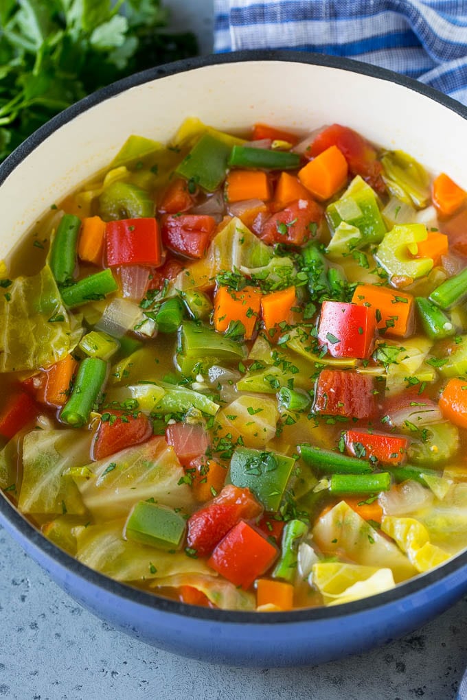 Cabbage Soup Recipe | Vegetable Soup | Veggie Soup | Healthy Soup #soup #healthy #cleaneating #cabbage #vegetables #veggies #dinner #sraye A pot of cabbage soup with carrots, celery, bell peppers and green beans.