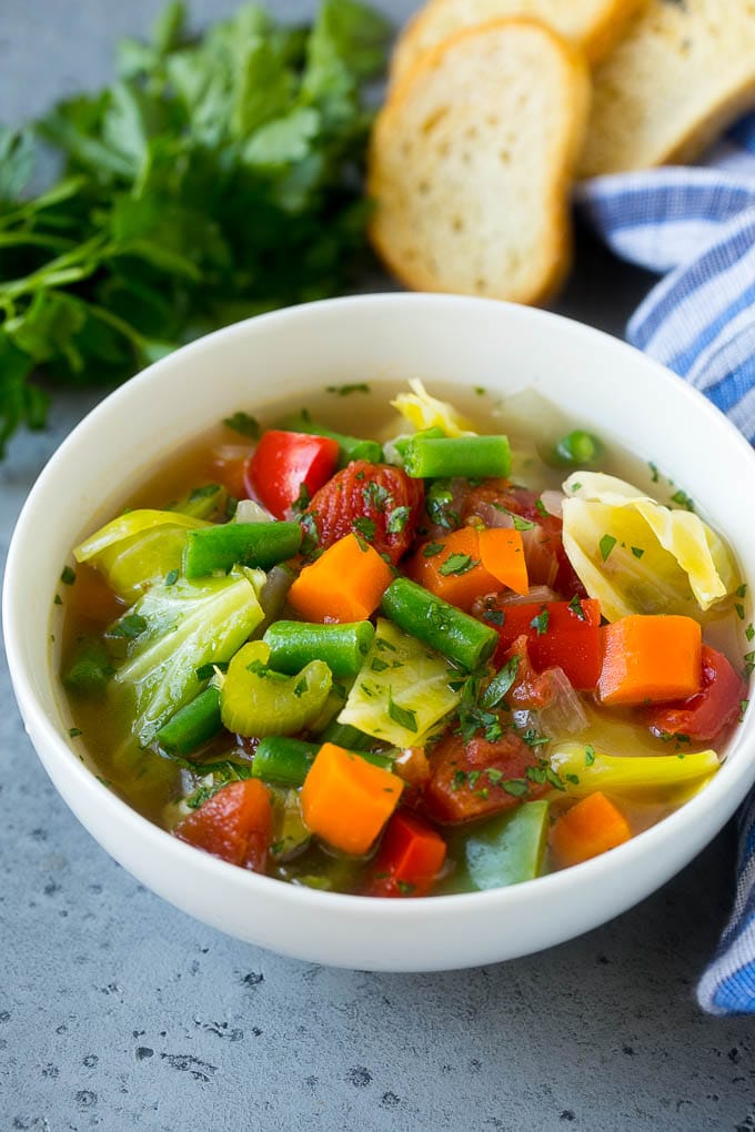 Cabbage Soup Recipe | Vegetable Soup | Veggie Soup | Healthy Soup #soup #healthy #cleaneating #cabbage #vegetables #veggies #dinner #sraye A bowl of cabbage soup with carrots, celery and tomatoes in broth.