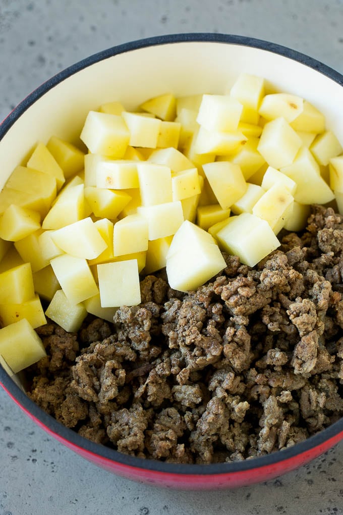 Cheeseburger Soup Recipe | Hamburger Soup | Cheese Soup #soup #groundbeef #hamburger #cheese #bacon #dinner #sraye Cooked ground beef and potatoes in a pot.