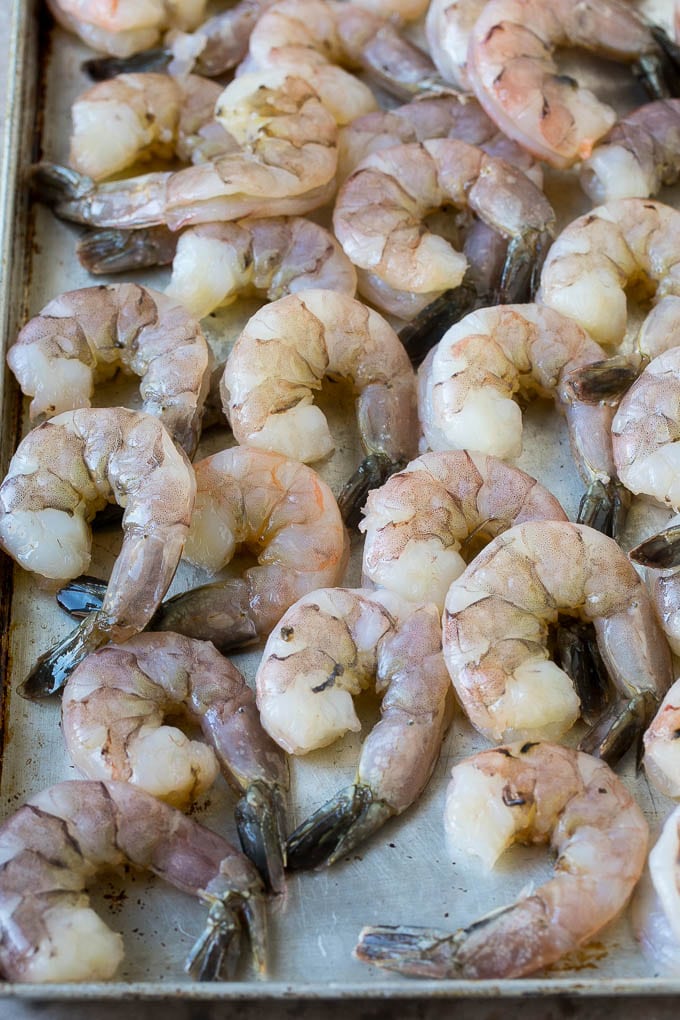 Coconut Shrimp Recipe | Fried Shrimp | Shrimp Appetizer #shrimp #coconut #appetizer #seafood #dinner #sraye Large raw tail-on shrimp arranged on a sheet pan.