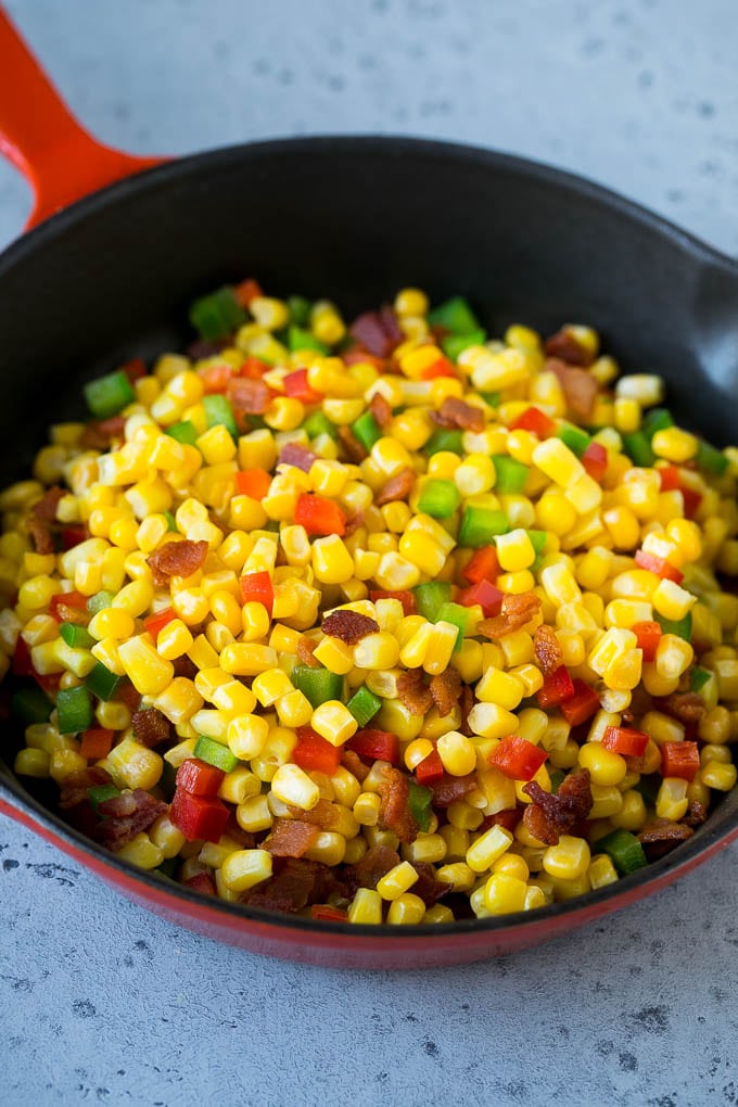 Corn Dip Recipe | Hot Cheese Dip | Bacon Dip #corn #dip #bacon #cheese #appetizer #snack #sraye Corn, bacon and bell peppers in a skillet.