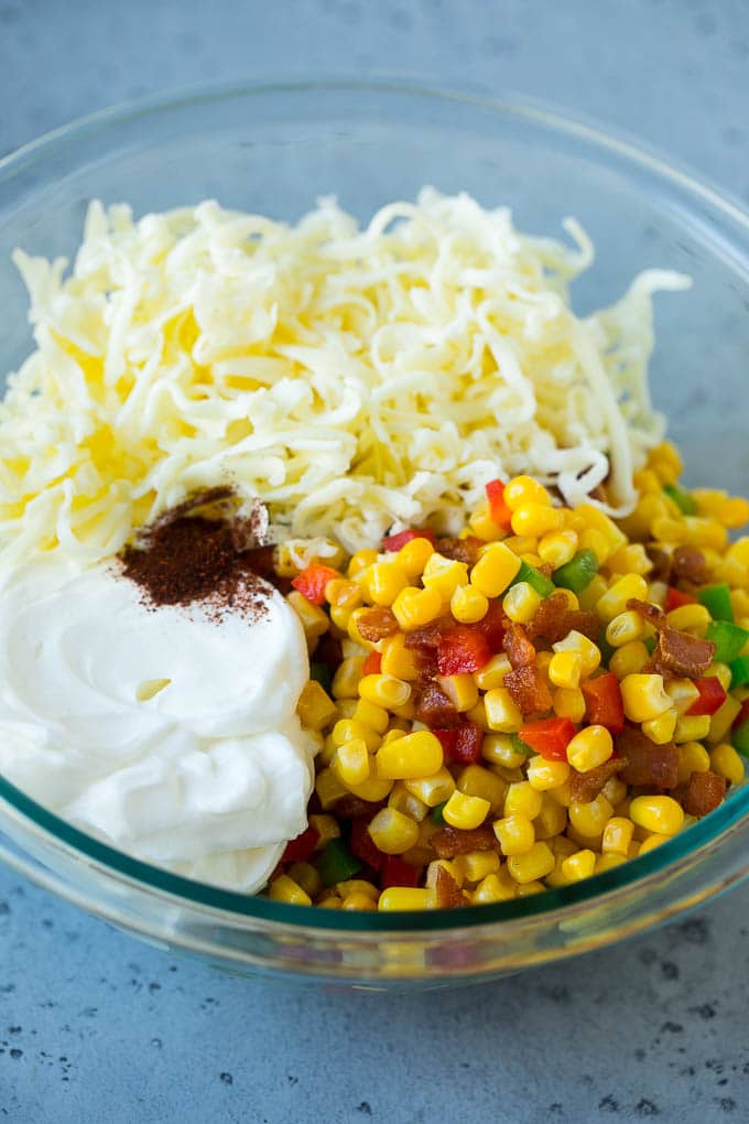 Corn Dip Recipe | Hot Cheese Dip | Bacon Dip #corn #dip #bacon #cheese #appetizer #snack #sraye Corn, bacon, bell peppers, sour cream and cheese in a mixing bowl.