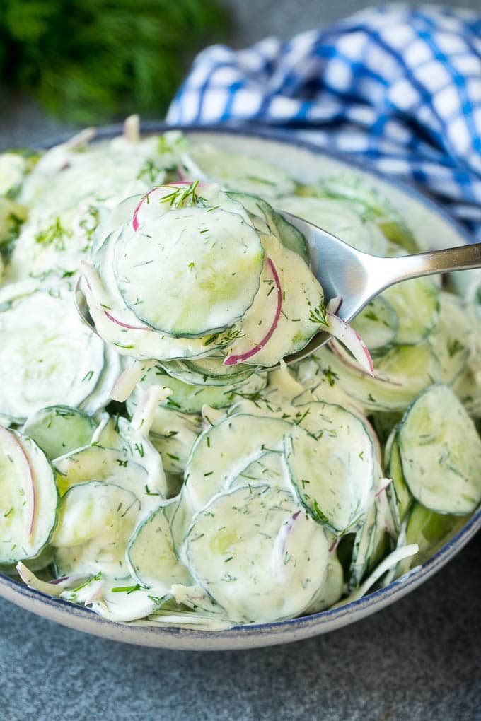 Creamy Cucumber Salad Recipe | German Cucumber Salad | Cucumber Salad #cucumber #salad #dinner #lunch #sraye #cucumbersalad A spoon serving up a portion of creamy cucumber salad.
