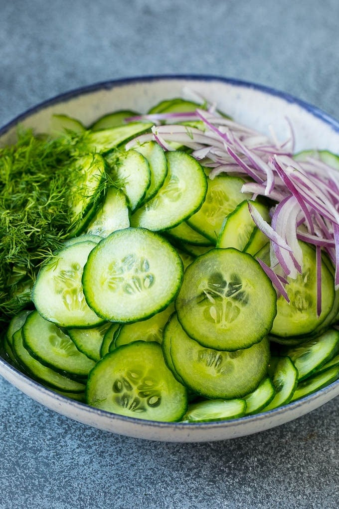 Cucumber Salad Recipe | Cucumber Dill Salad | Cucumber Recipe #cucumbers #salad #glutenfree #sidedish #sraye Ingredients including red onion and dill in a bowl.